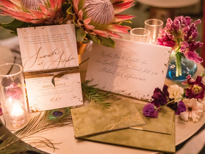 Green velvet invitation suite with white and gold accents.